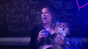 Deb played by Linda Kash winking at the bar