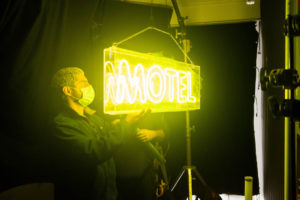 Hanging the otel sign behind the scenes of sloppy jones